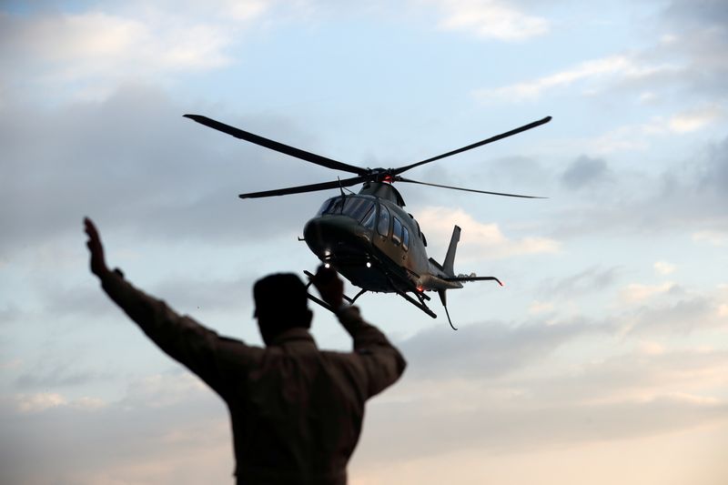 A helicopter carryying Cambodia's Prime Minister Hun Sen arrives at the port as MS Westerdam a cruise ship that spent two weeks at sea after being turned away by five countries over fears that someone aboard might have the coronavirus docks in Sihanoukv