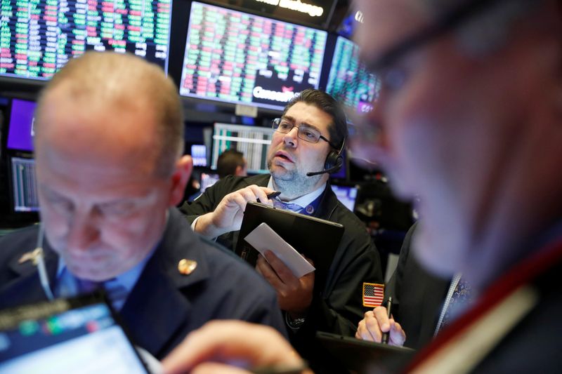 Traders work on the floor of the New York Stock Exchange shortly after the opening bell in New York