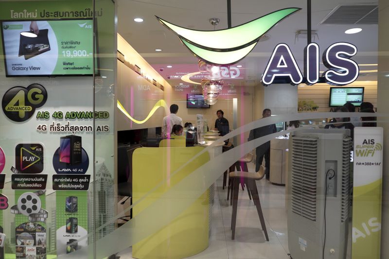 Customers wait for service at the AIS shop in Bangkok