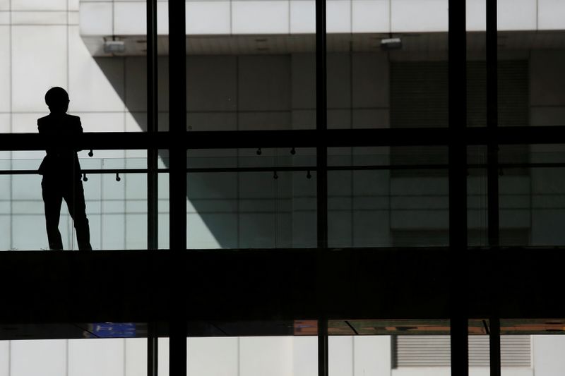FILE PHOTO: A woman talks on phone inside the Bank of China head office building in Beijing