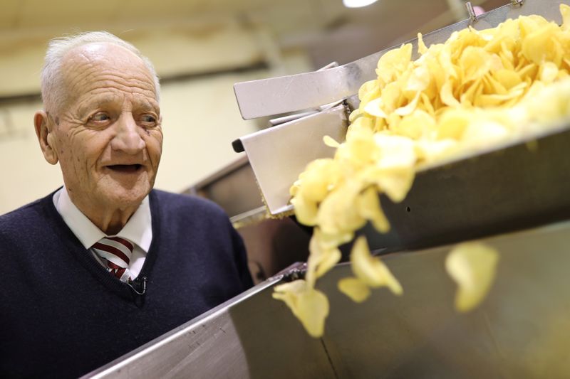 Bonilla, 87, looks at potato chip production during interview with Reuters inside his Bonilla a la Vista factory in Arteixo