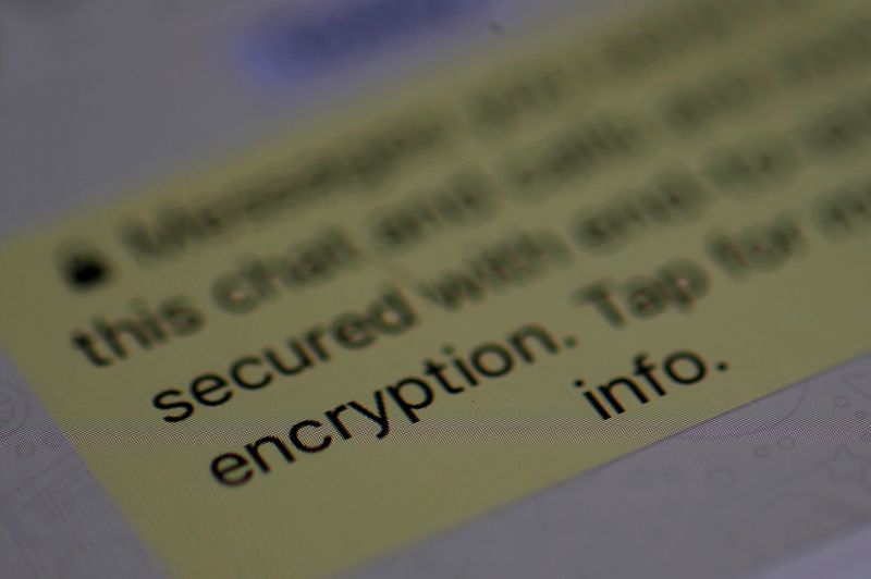 FILE PHOTO: An encryption message is seen on the WhatsApp application on an iPhone i