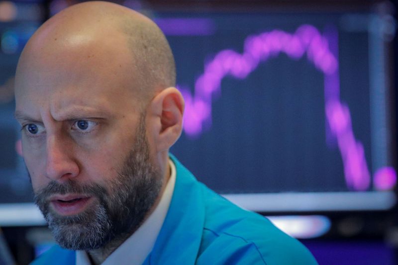 FILE PHOTO: A trader work on the floor at the NYSE in New York on Feb 27, 2020