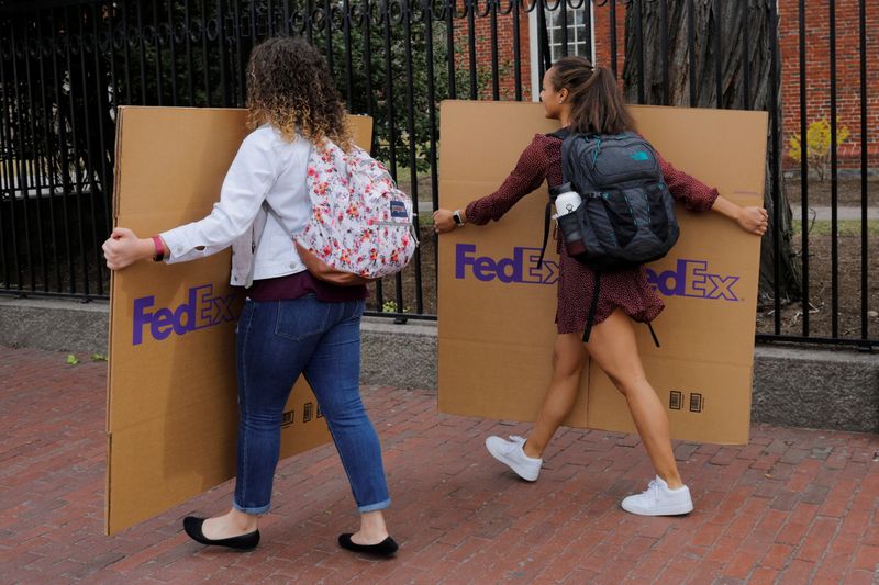 Students carry boxes to their dorms at Harvard University in Cambridge