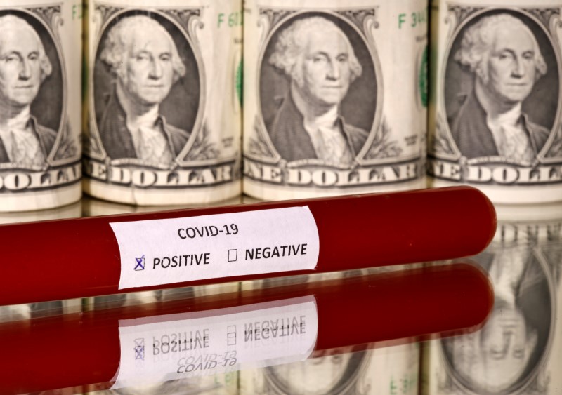 FILE PHOTO: Picture illustration of a test tube labelled with the coronavirus is seen in front of U.S. dollar banknotes