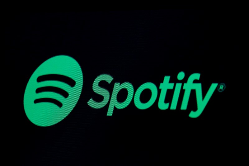 The Spotify logo is displayed on a screen on the floor of the NYSE in New York