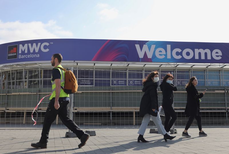 Employees pass by Fira de Barcelona after the Mobile World Congress (MWC) was cancelled in Barcelona