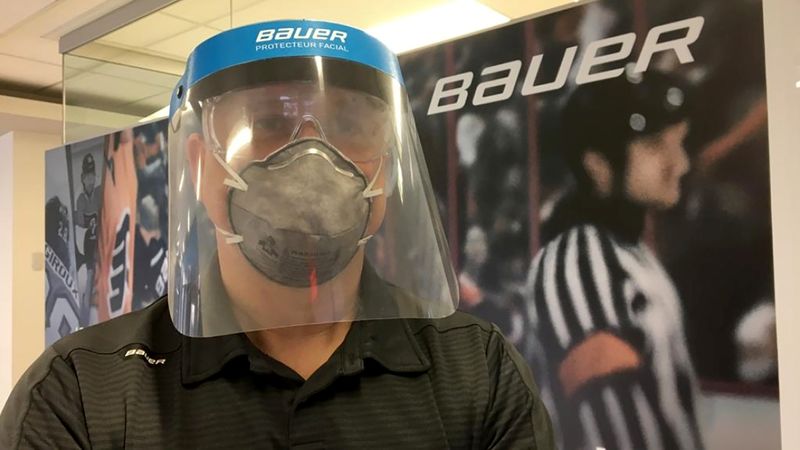 A staff member wears a medical visor produced by Bauer Hockey for medical staff fighting the spread of coronavirus disease