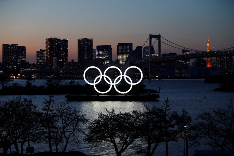 The giant Olympic rings are seen in the dusk at the waterfront area at Odaiba Marine Park after postponing Games due to the outbreak of coronavirus disease (COVID 19), in Tokyo
