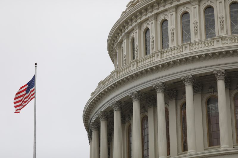 FILE PHOTO: The U.S. Capitol during a morning rainstorm, after Congress agreed to a multi-trillion dollar economic stimulus package created in response to the economic fallout from the COVID-19 Coronavirus, on Capitol Hill in Washington