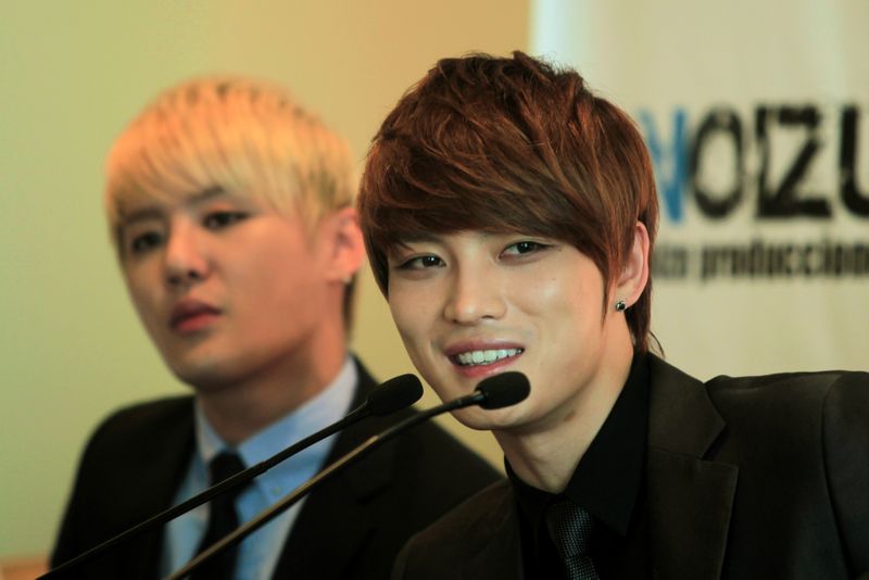FILE PHOTO: Kim Jaejoong (R) of South Korean pop group JYJ speaks to a news conference in Lima, Peru