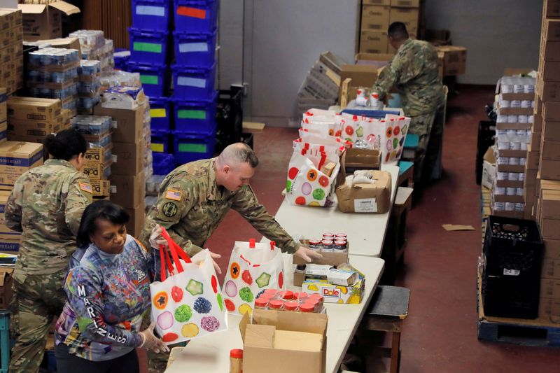 FILE PHOTO: Members of the New York Army National Guard help pack pantry bags for food distribution with Hope Community Services in an area with multiple cases of the coronavirus disease (COVID-19) in New Rochelle, New York