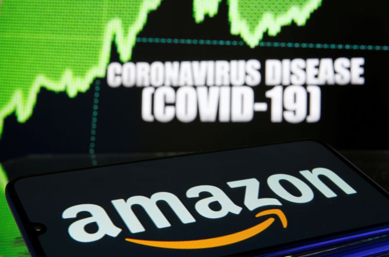 FILE PHOTO: FILE PHOTO: Amazon logo is seen in front of diplayed coronavirus disease (COVID-19)
