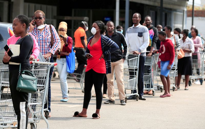 FILE PHOTO: People queue to shop ahead of a nationwide 21 day lockdown called by the government to limit the spread of coronavirus disease (COVID-19) in Harare