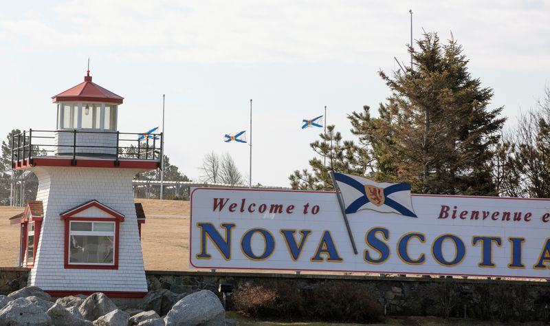 Nova Scotia flags are lowered on the New Brunswick/Nova Scotia border a day after a mass shooting by Gabriel Wortman, in Fort Lawrence
