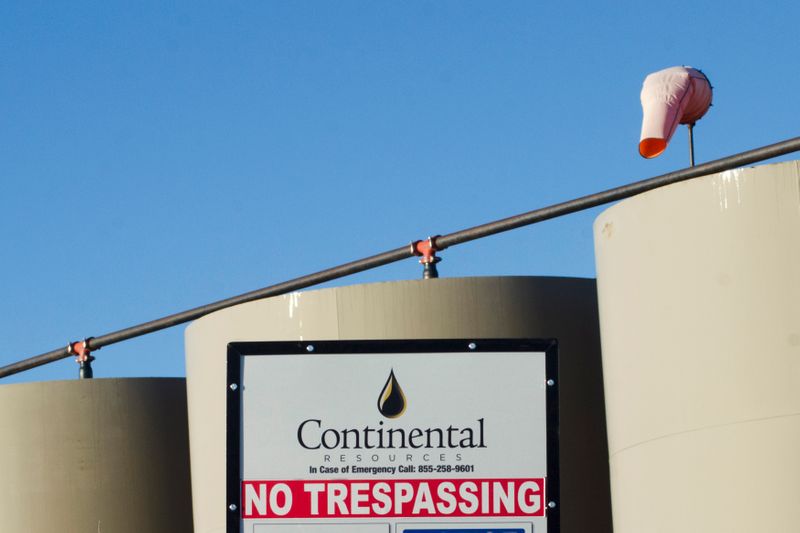 FILE PHOTO: Storage tanks stand on a Continental Resources oil production site near Williston