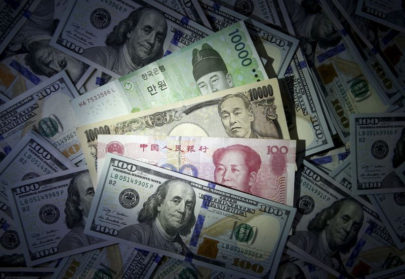 File photo illustration of South Korean won, Chinese yuan and Japanese yen notes seen on U.S. 100 dollar notes