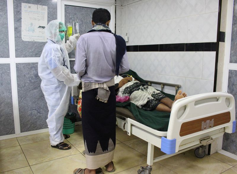 A medic wearing a protective suit attends to a patient at the emergency ward of a hospital amid concerns about the spread of the coronavirus disease (COVID-19) in Aden