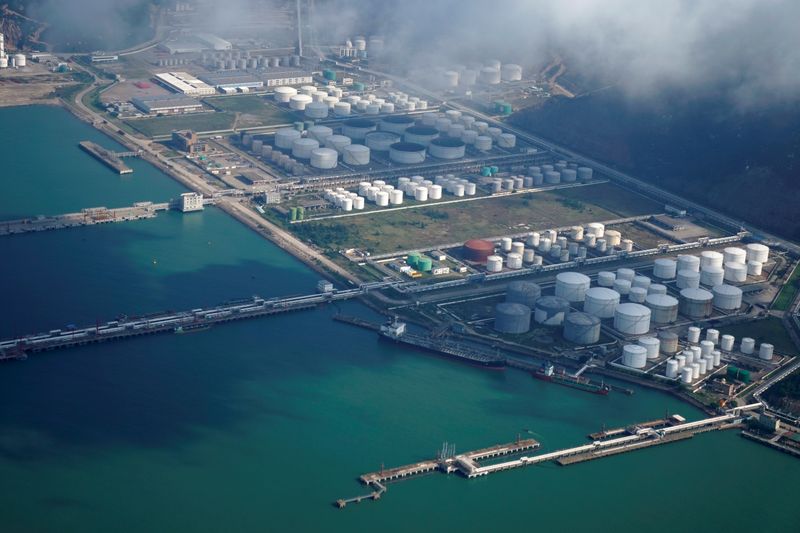 FILE PHOTO: Oil and gas tanks are seen at an oil warehouse at a port in Zhuhai