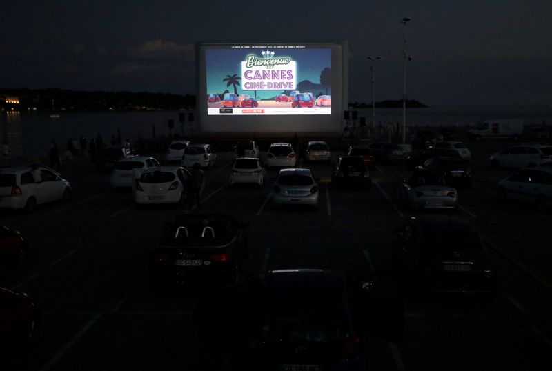 FILE PHOTO: People sit in their cars to watch E.T. at drive-in cinema in Cannes