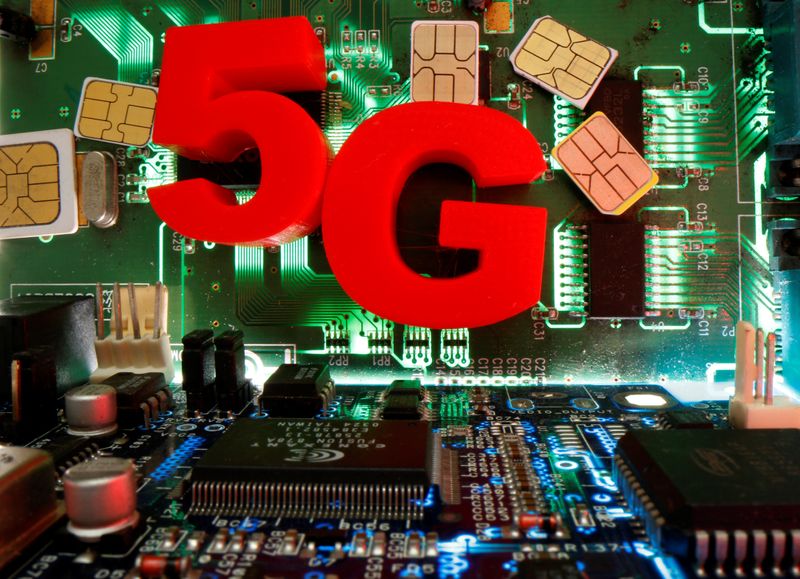 FILE PHOTO: SIM cards and 3d printed objects representing 5G are put on a motherboard in this picture illustration