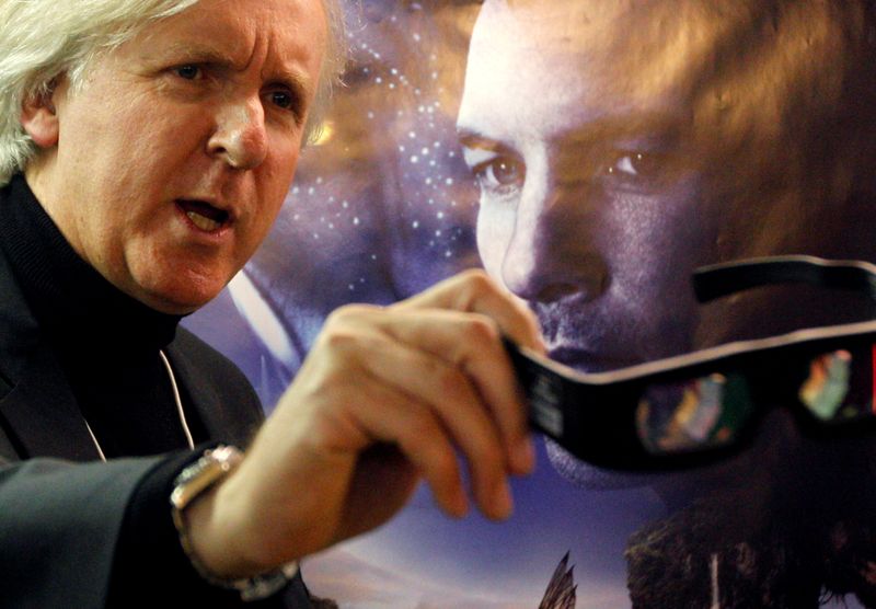 FILE PHOTO: Canadian director Cameron poses in front of a poster before a promotion event for his latest movie Avatar at the WEF in Davos
