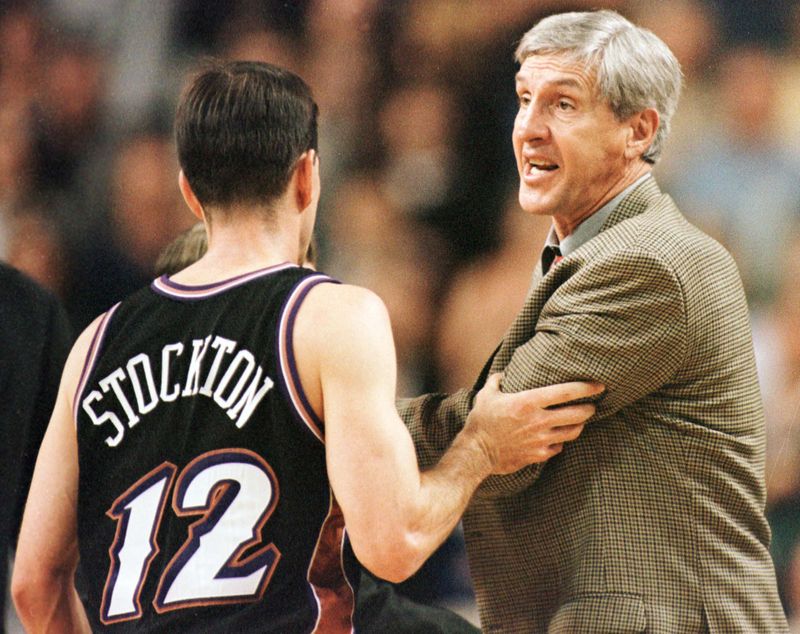JAZZS COACH SLOAN RESTRAINED DURING GAME AGAINST SONICS.