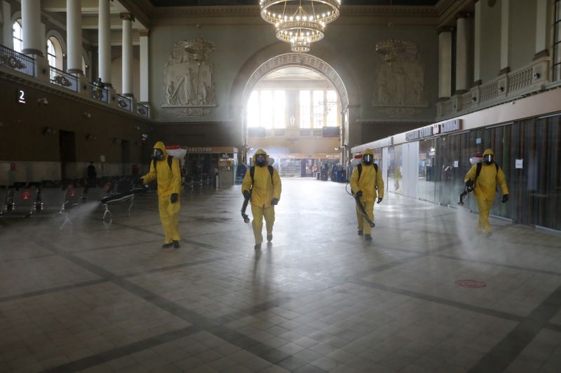 FILE PHOTO: Emergencies Ministry members sanitize a railway station amid the outbreak of the coronavirus disease in Moscow