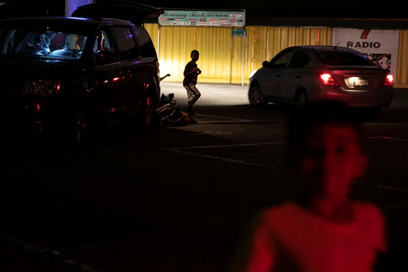 People enjoy movies at a drive-in theatre while keeping social distancing following the outbreak of the coronavirus disease in Fort Lauderdale