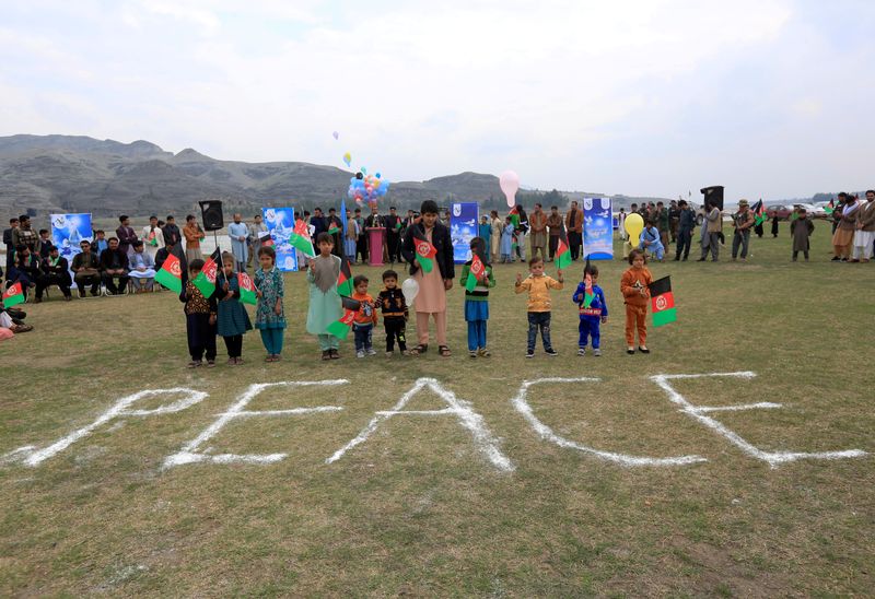FILE PHOTO: Afghan children celebrate in anticipation of the U.S-Taliban agreement to allow a U.S. troop reduction and a permanent ceasefire, in Jalalabad