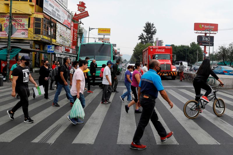 People cross a road in the municipality of Iztapalapa as the outbreak of the coronavirus disease (COVID-19) continues in Mexico City