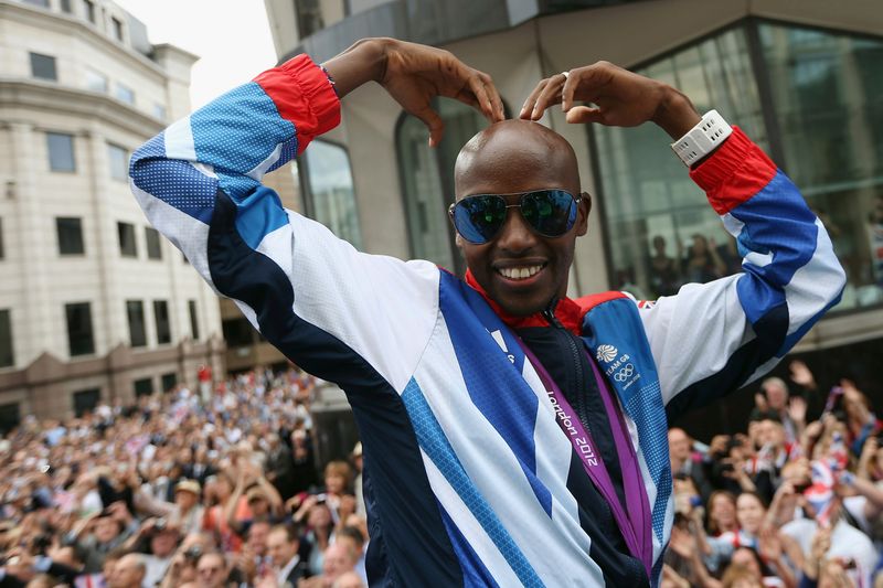 Long distance runner Mo Farah makes his trademark