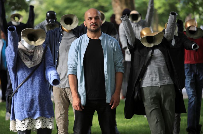 Syrian artist Barakeh amid installation