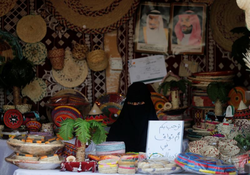 A Saudi woman sits in her shop at heritage village during Gulf Coastal Cultural Festival at Dammam Corniche, Dammam