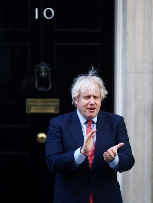 FILE PHOTO: British Prime Minister Boris Johnson applauds the NHS outside 10 Downing Street in May