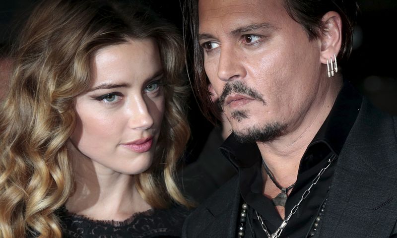 Cast member Johnny Depp and his actress wife Amber Heard arrive for the British premiere of the film