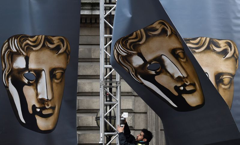 FILE PHOTO: An event worker attaches set parts during preparations for the BAFTA awards ceremony in London