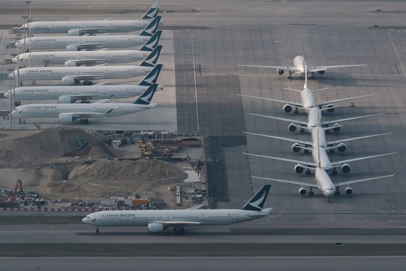 FILE PHOTO: Cathay Pacific aircraft are seen parked on the tarmac at the airport, following the outbreak of the new coronavirus, in Hong Kong