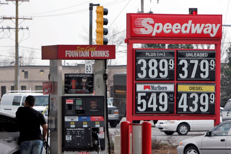 FILE PHOTO: Robert Giatras fuels-up his car at a Speedway gas station in Des Plaines, Illinois