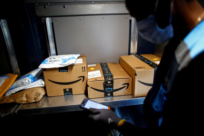 FILE PHOTO: An Amazon worker delivers packages
