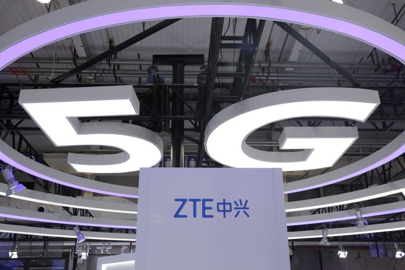 FILE PHOTO: The logo for ZTE, a popular pick among Korean investors, and a sign for 5G are seen at the World 5G Exhibition in Beijing