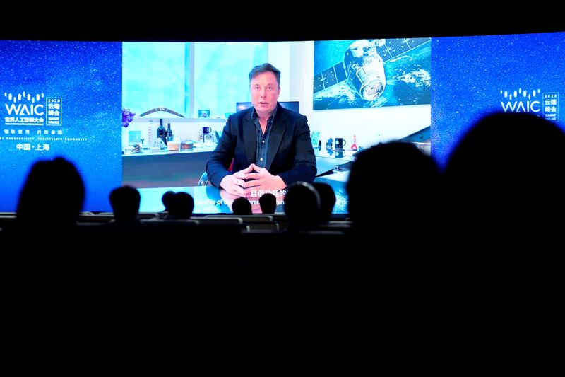 FILE PHOTO: Tesla Inc CEO Elon Musk is seen on a screen during the opening ceremony of the WAIC in Shanghai