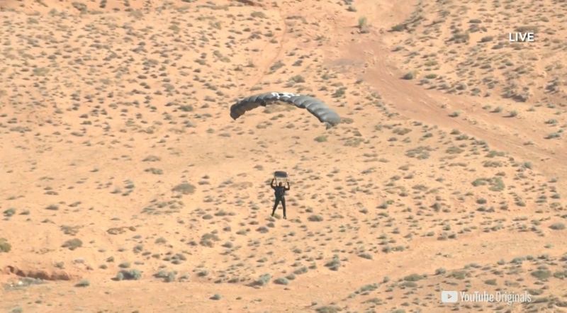 Extreme performer Blaine approaches a landing wearing a parachute over Arizona