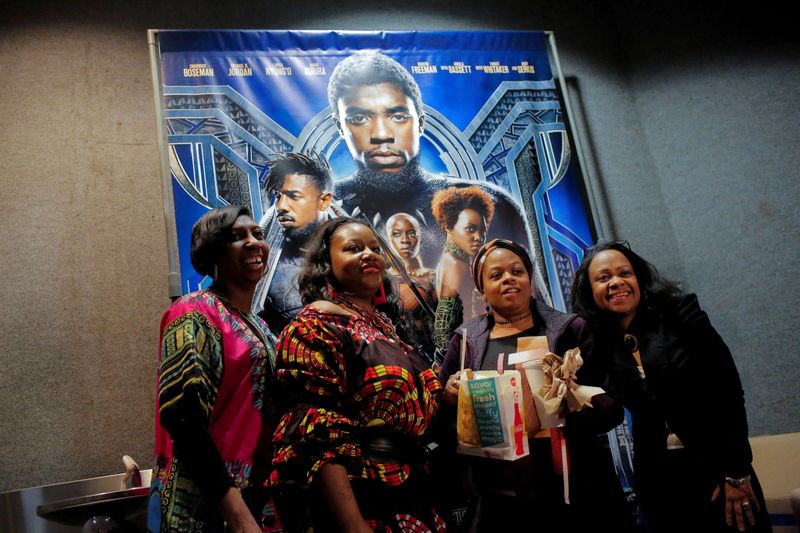 FILE PHOTO: A group of women pose for a photo in front of a poster advertising the film