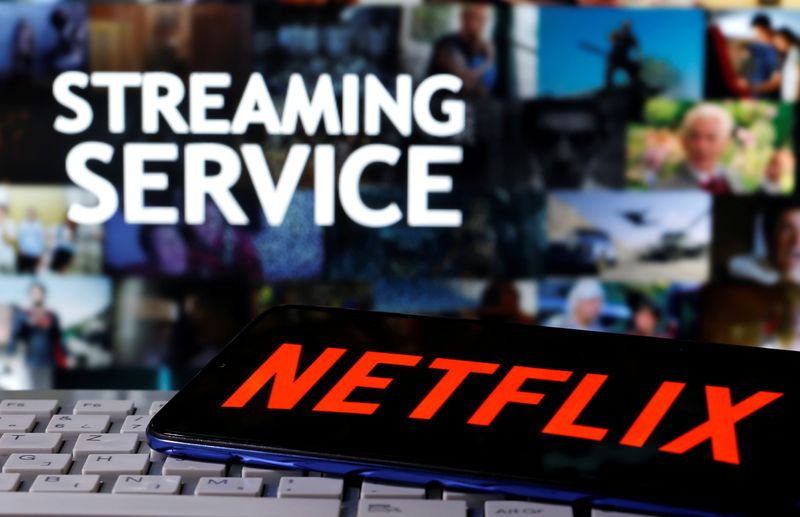 FILE PHOTO: A smartphone with the Netflix logo is seen on a keyboard in front of displayed
