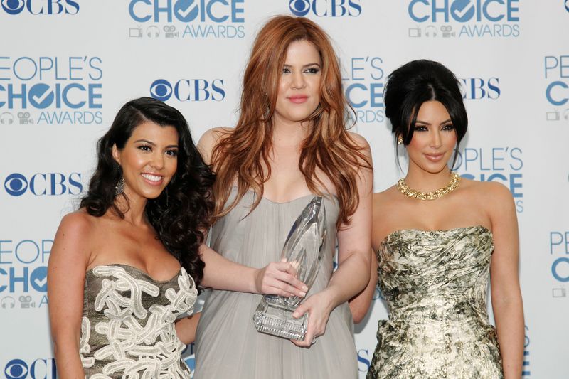 FILE PHOTO: Reality TV sisters Kourtney, Khloe and Kim Kardashian pose with their favorite guilty pleasure award at the 2011 People's Choice Awards in Los Angeles