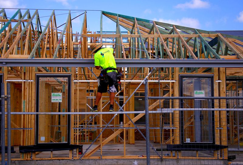 A tradesman works on the roof of a house under construction at a housing development located in the western Sydney suburb of Oran Park