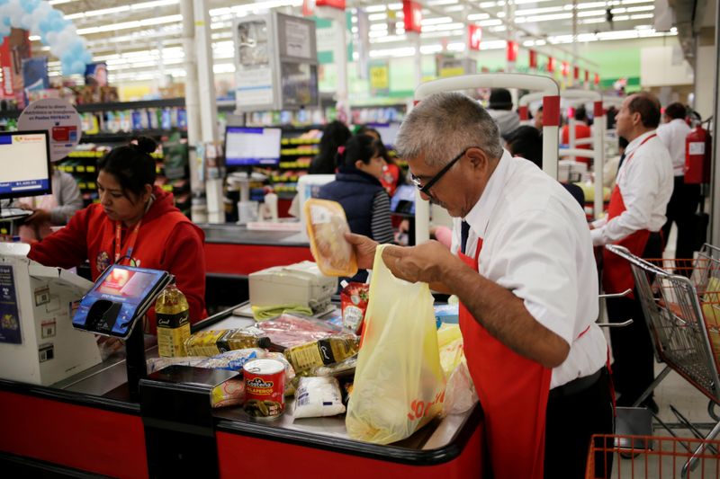 A man packs goods in a supermarket in Ciudad Juarez