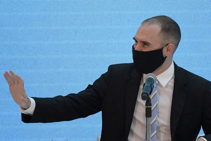 FILE PHOTO: Argentina's Economy Minister Martin Guzman waves before attending a news conference to give details about the agreement to restructure Argentina's debt, at the Casa Rosada Presidential Palace, in Buenos Aires