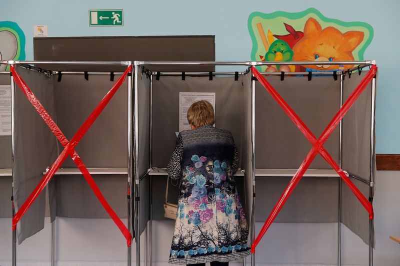 Woman checks her ballot in a voting booth during local elections in the Siberian city of Tomsk